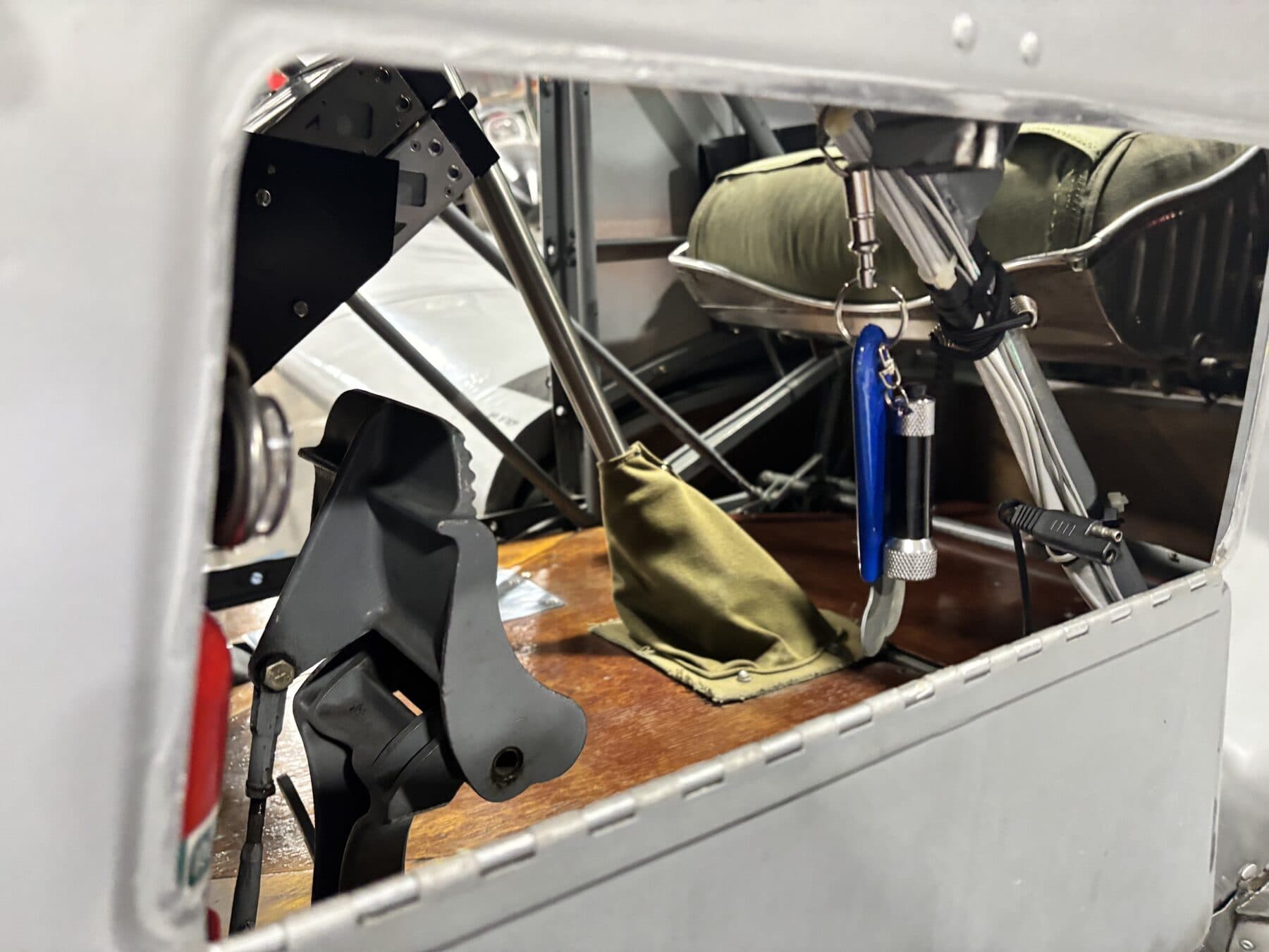 Inside the cockpit of PT-26 Cornell N49071, looking at the control stick and wooden floor